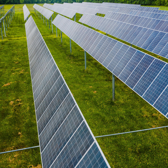 Off-Grid Solar Systems in a garden with pallet of solar panels