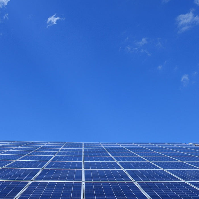 Solar Panel Installation in a clear blue sky with clouds