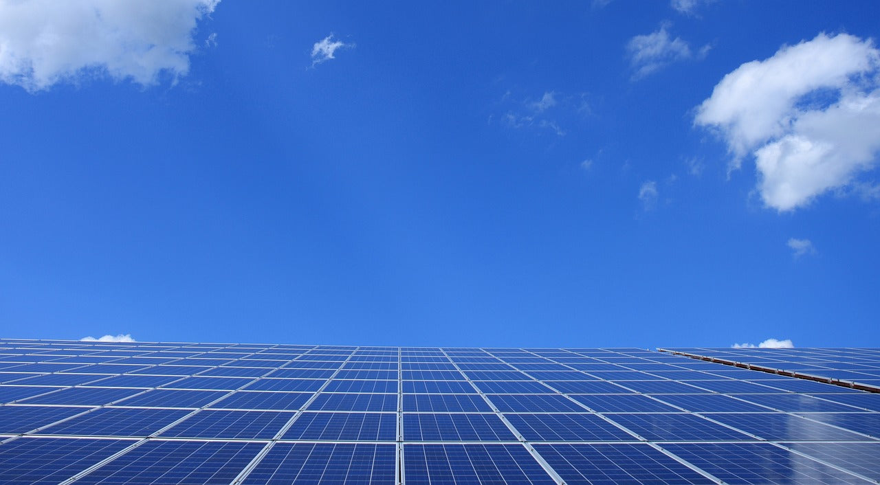 Solar Panel Installation in a clear blue sky with clouds